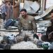 Civil defence members rest amid rubble of damaged buildings after an airstrike on the rebel-held Tariq al-Bab neighbourhood of Aleppo, Syria April 23, 2016. REUTERS/Abdalrhman Ismail